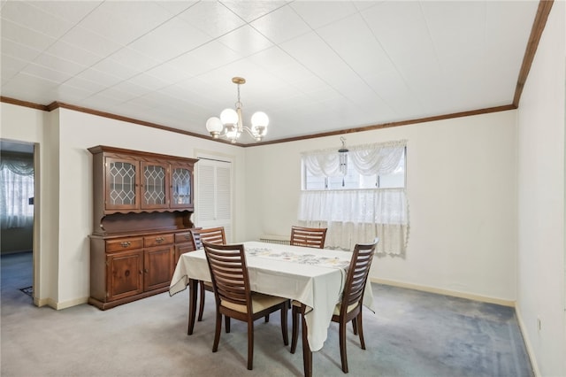 carpeted dining room with ornamental molding and an inviting chandelier