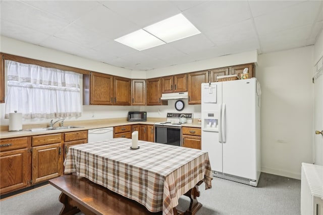 kitchen featuring light colored carpet, white appliances, and sink