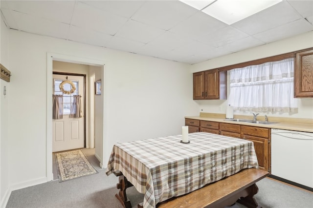 kitchen with dishwasher, a healthy amount of sunlight, light colored carpet, and sink