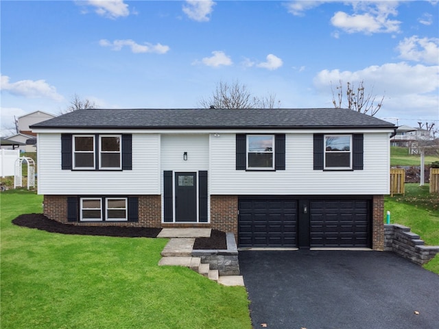 raised ranch with a front yard and a garage