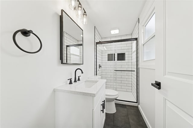 bathroom with tile patterned flooring, vanity, toilet, and an enclosed shower