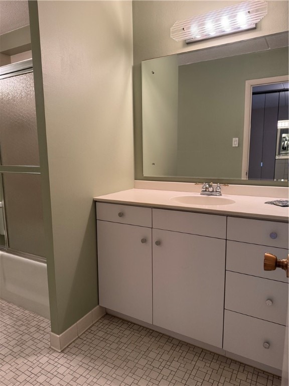 bathroom featuring shower / bath combination with glass door, tile patterned floors, and vanity