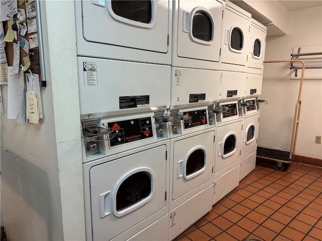 laundry area featuring independent washer and dryer, dark tile patterned floors, and stacked washer / dryer