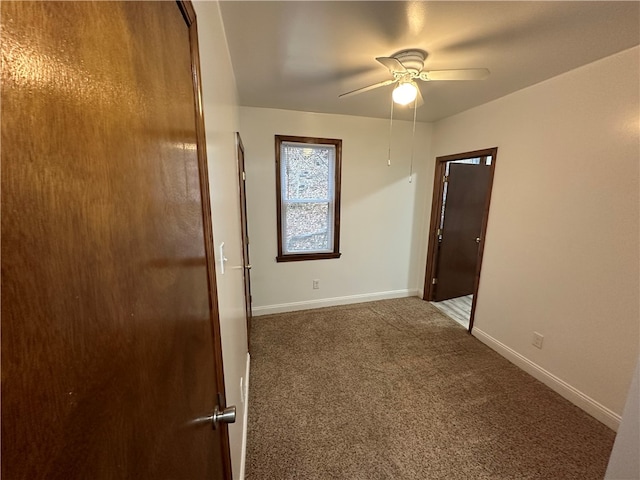 carpeted spare room with ceiling fan