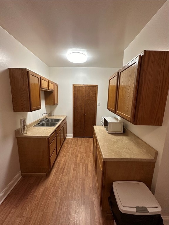 kitchen featuring light wood-type flooring and sink