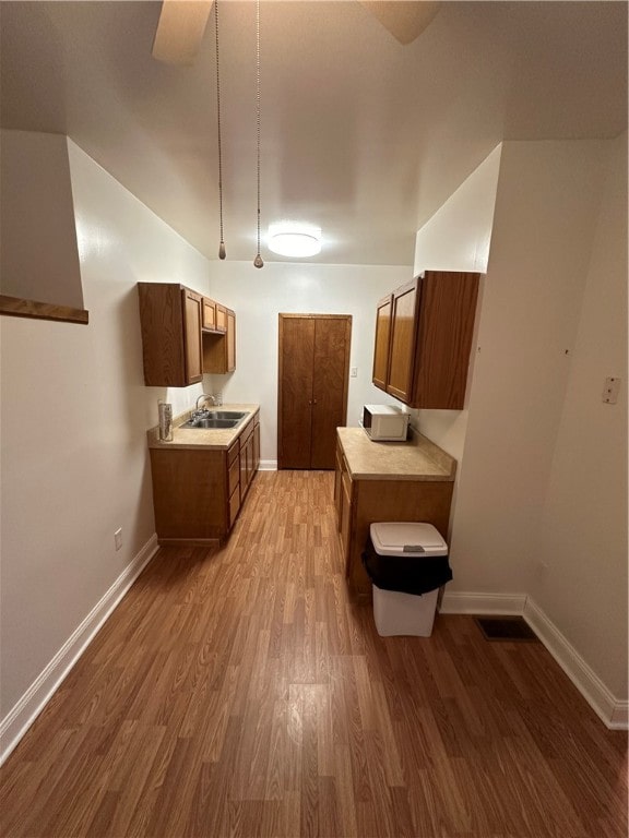 kitchen with hardwood / wood-style flooring and sink