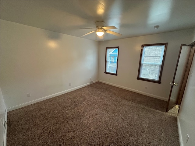 carpeted spare room featuring ceiling fan