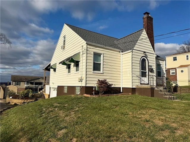 rear view of property featuring a lawn