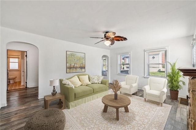 living room featuring dark hardwood / wood-style floors and ceiling fan