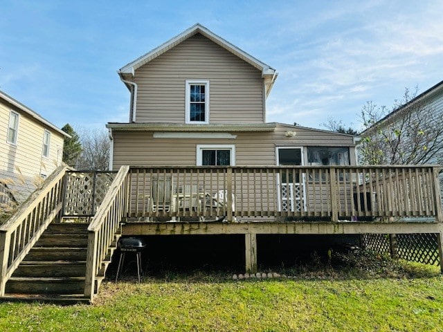 back of house with a lawn and a deck