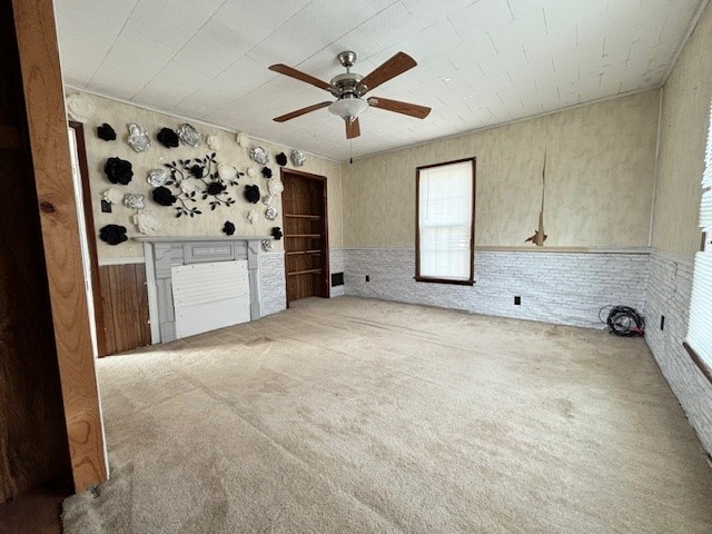 interior space with light colored carpet and ceiling fan