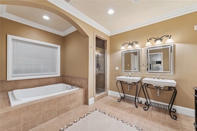 bathroom with separate shower and tub, tile patterned floors, crown molding, and sink