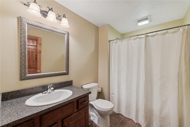 bathroom featuring toilet, vanity, and tile patterned floors