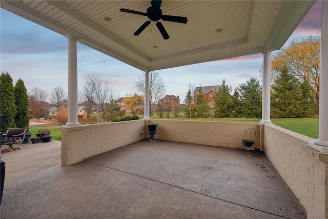 patio terrace at dusk featuring ceiling fan