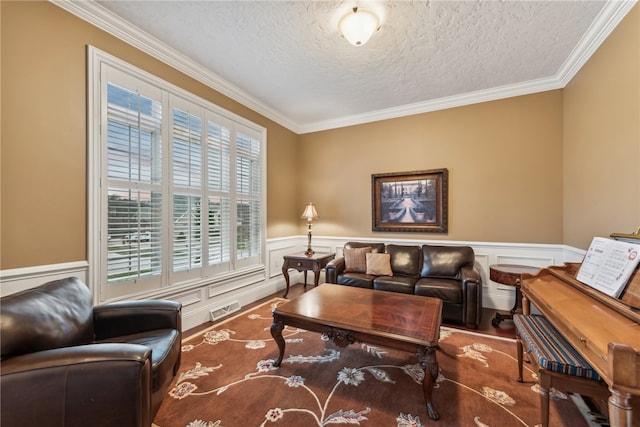 living room featuring hardwood / wood-style floors, ornamental molding, and a textured ceiling