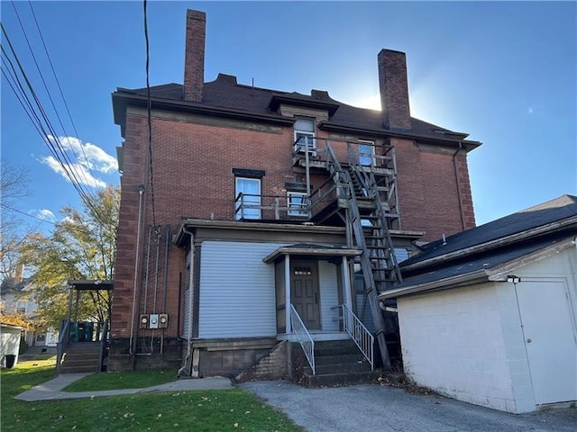 rear view of property featuring a lawn