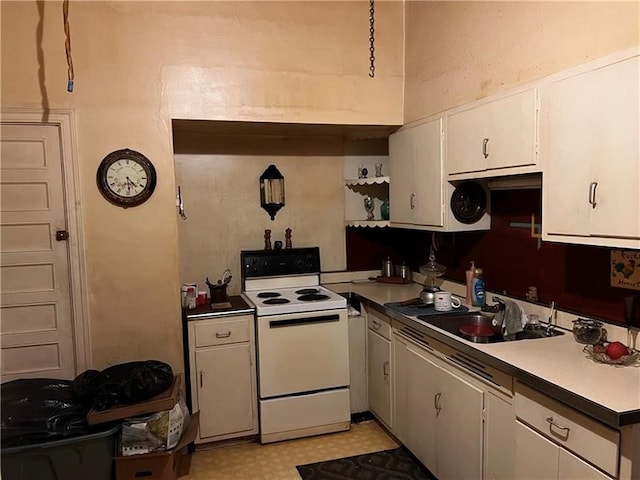 kitchen featuring white cabinets, sink, and electric stove