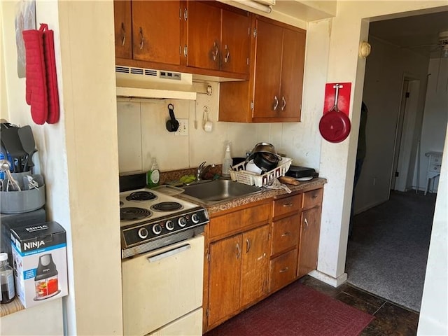 kitchen featuring dark tile patterned flooring, electric stove, sink, and extractor fan