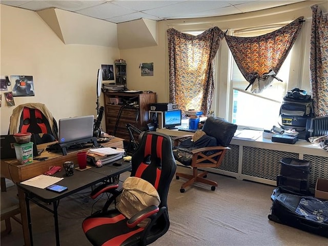 carpeted home office featuring a paneled ceiling