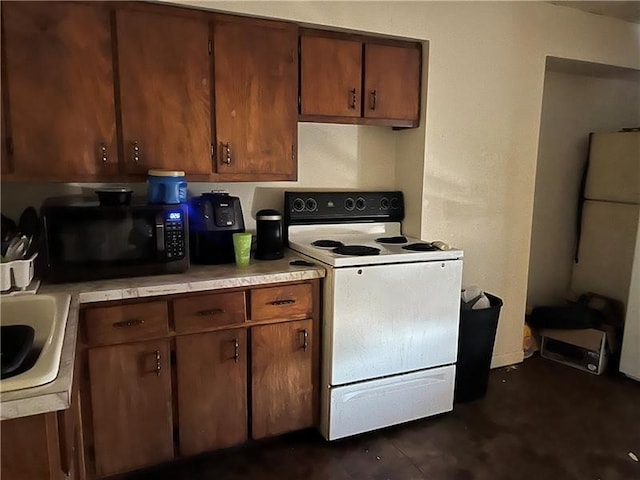 kitchen with white range with electric cooktop and sink