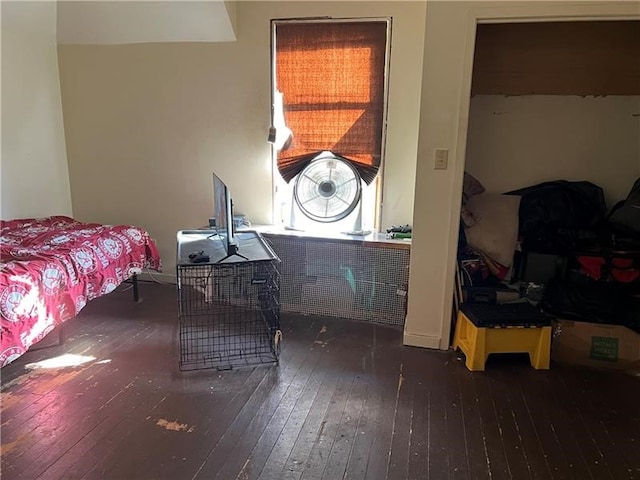 bedroom with dark wood-type flooring