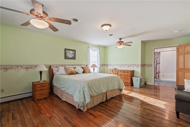 bedroom with ceiling fan, dark hardwood / wood-style floors, and baseboard heating