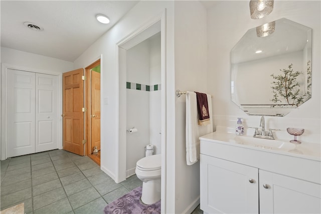 bathroom featuring tile patterned floors, vanity, and toilet