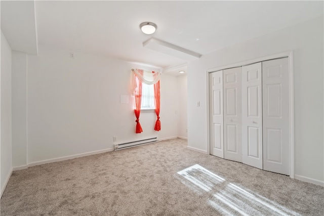 unfurnished bedroom with a closet, light colored carpet, and a baseboard radiator