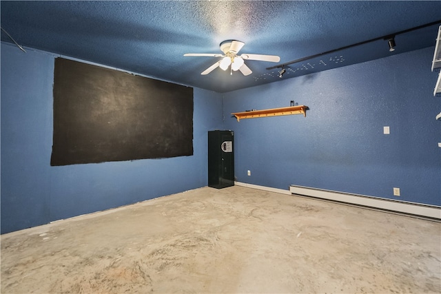 unfurnished room featuring concrete flooring, a textured ceiling, a baseboard radiator, and ceiling fan