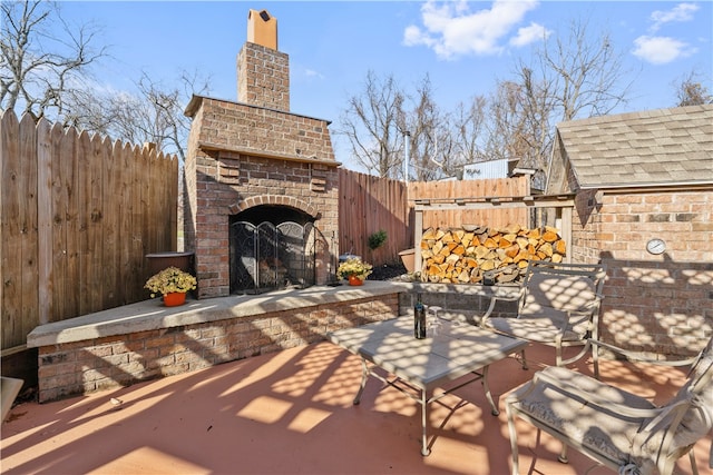 view of patio / terrace with an outdoor brick fireplace