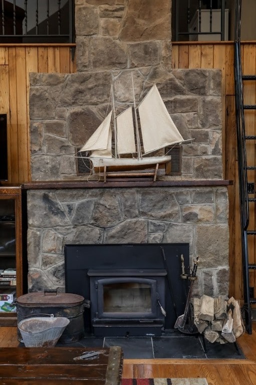 interior details with a wood stove and hardwood / wood-style flooring