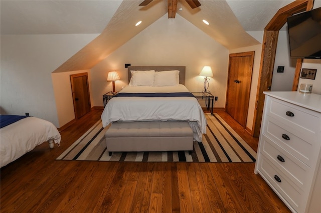 bedroom with ceiling fan, dark hardwood / wood-style flooring, and lofted ceiling with beams