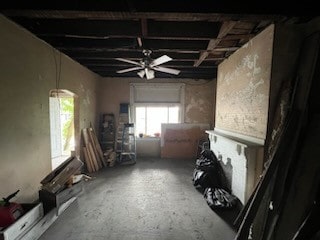 misc room featuring ceiling fan and concrete flooring