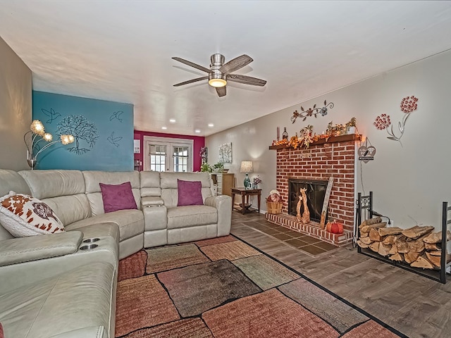 living room featuring hardwood / wood-style flooring, a brick fireplace, and ceiling fan