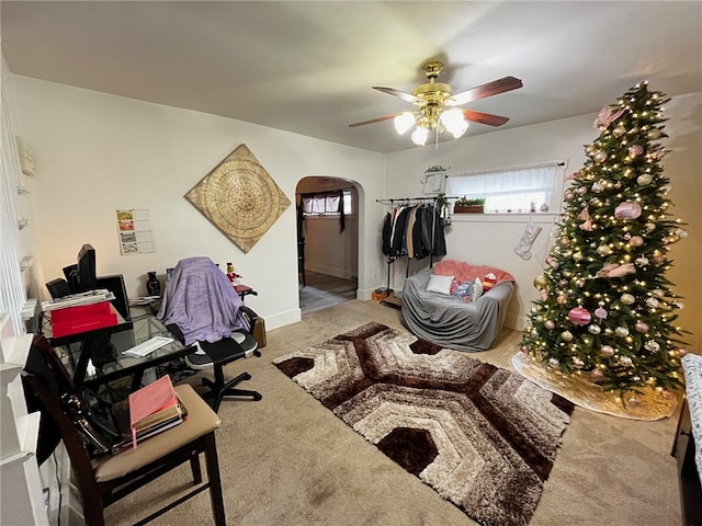 interior space featuring carpet flooring and ceiling fan