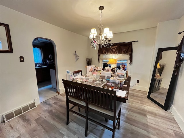 dining area with a chandelier and hardwood / wood-style floors