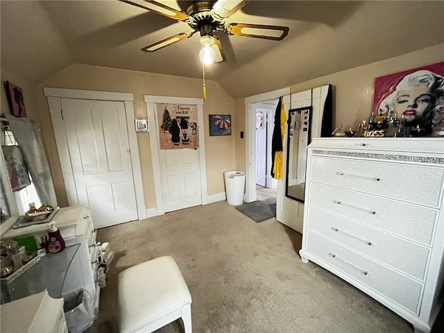 carpeted bedroom with ceiling fan and vaulted ceiling