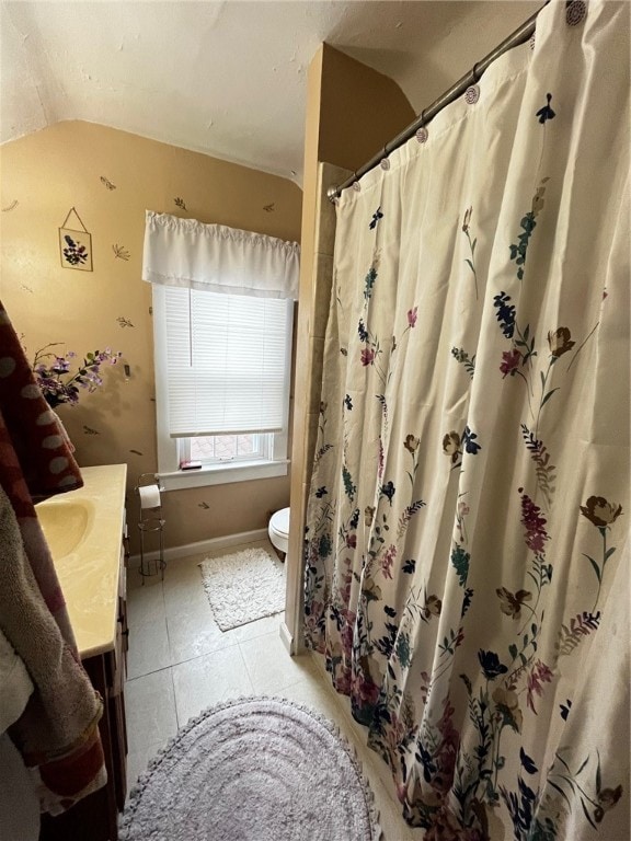 bathroom featuring tile patterned flooring, vanity, and toilet