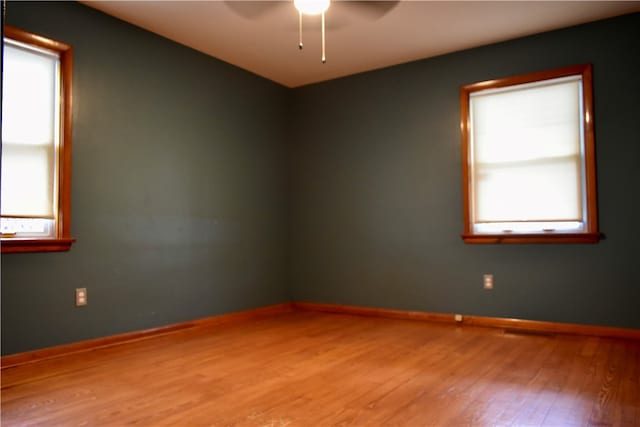 unfurnished room featuring hardwood / wood-style flooring and ceiling fan