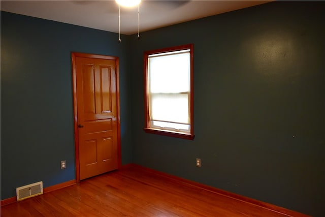 spare room with hardwood / wood-style flooring and ceiling fan