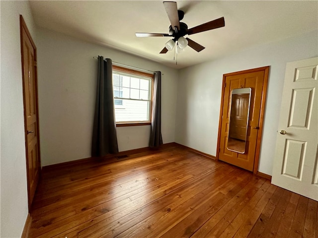 unfurnished bedroom featuring hardwood / wood-style flooring and ceiling fan