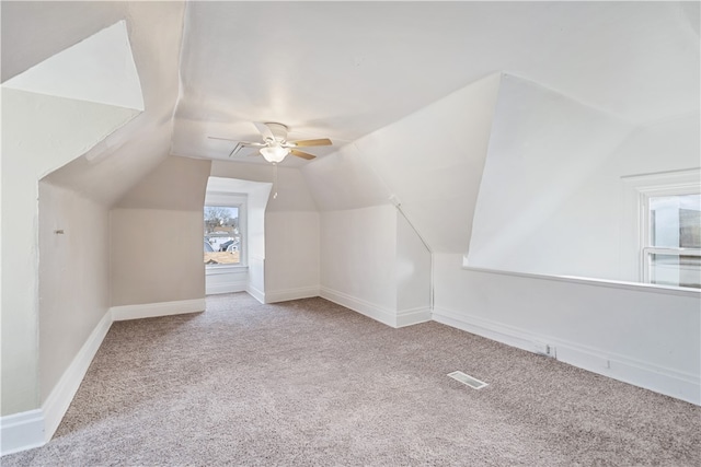 additional living space with ceiling fan, light carpet, and vaulted ceiling