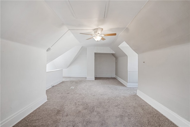 additional living space featuring ceiling fan, light colored carpet, and vaulted ceiling