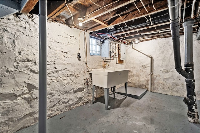 basement featuring sink and electric panel