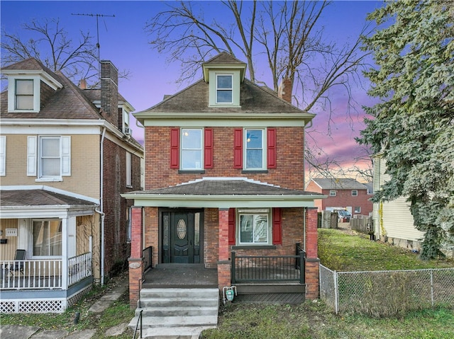 view of front of property with a lawn and covered porch