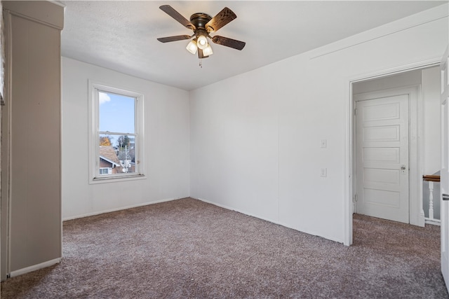 unfurnished room with carpet flooring and ceiling fan