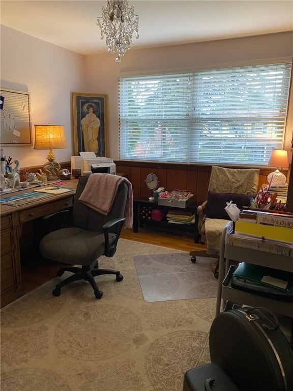 office space featuring light hardwood / wood-style floors and an inviting chandelier