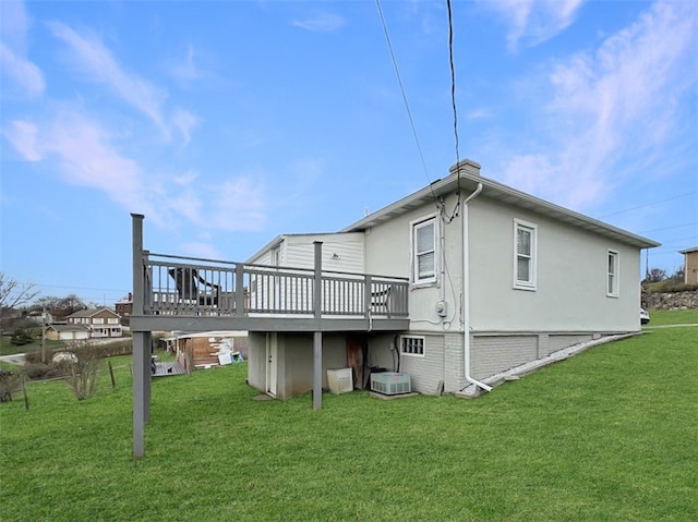 back of property featuring a lawn, a wooden deck, and central AC