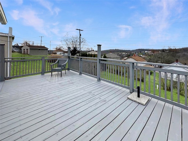 wooden deck featuring a yard