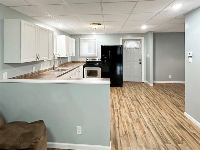 kitchen featuring sink, stainless steel range with electric cooktop, kitchen peninsula, black fridge with ice dispenser, and white cabinets